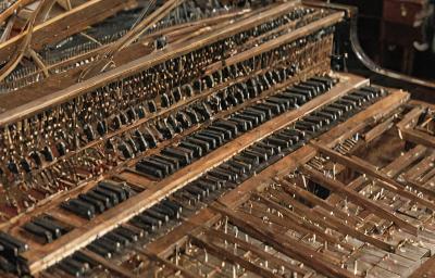 Concert grand piano restoration showing soundboard work