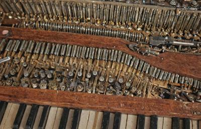 Wurlitzer spinet piano repair showing internal mechanism work