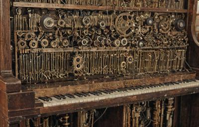 Antique player piano restoration with mechanical components